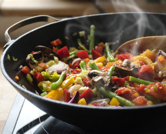 steaming mixed vegetables in the wok, asian style cooking