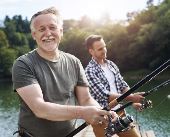 Portrait of cheerful senior man fishing