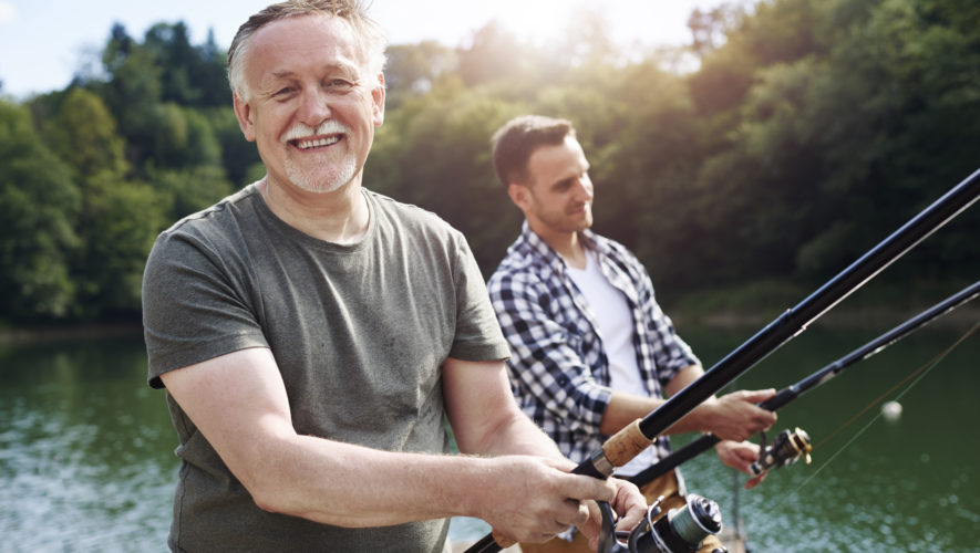 Portrait of cheerful senior man fishing