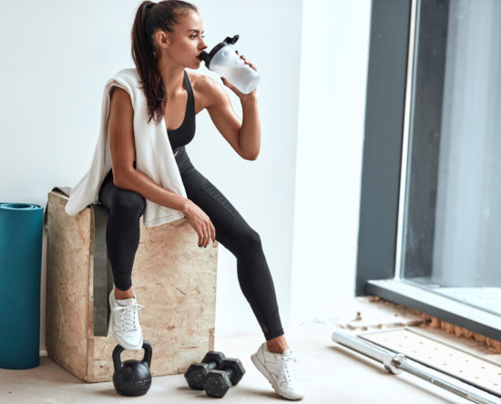 Young girl after training drink water. Health, sport, fitness concept