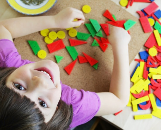 Preschool girl playing with puzzle